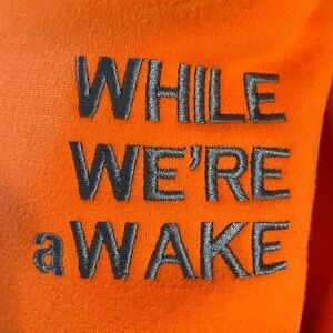 WHILE WE’RE aWAKE Multi String Hoodie. Neon orange.